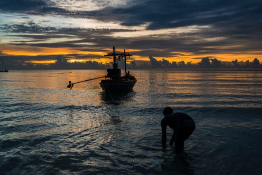 Fisherman prepare to work in dawn.