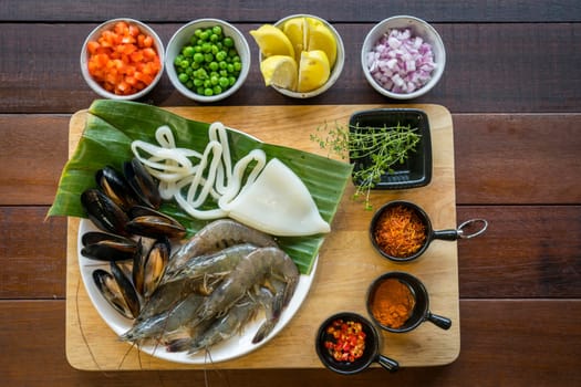 Raw seafood on plate, healthy food, prawn, clam squid.