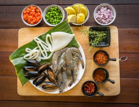 Raw seafood on plate, healthy food, prawn, clam squid.
