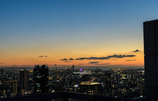 OSAKA, JAPAN - NOVEMBER 25, 2016 : Beautiful twilight view of Osaka commercial and business cityscape from Umeda Sky Building in Osaka, Japan. Osaka is the second largest metropolitan area in Japan.