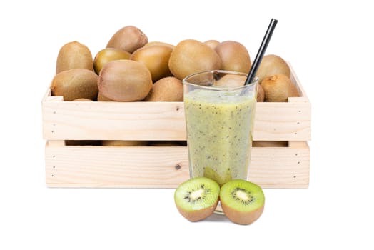 Wooden box with ripe kiwi fruits and a glass with fresh kiwi smoothie with a drinking straw isolated on white background