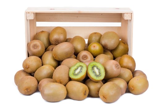 Wooden box with ripe and fresh kiwi fruits in front of it isolated on white background