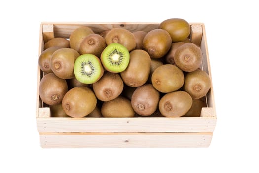 Wooden box filled with many ripe and fresh kiwi fruits and two half fruits isolated on white background