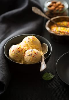 Homemade Organic Vanilla Ice Cream scoops decorated with colorful sprinkles