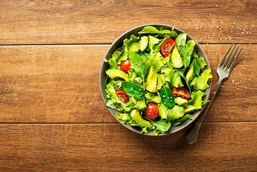 Fresh green lettuce salad with avocado and tomato