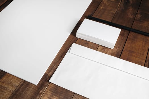 Corporate identity template. Blank stationery set on wood table background. For graphic designers presentations and portfolios.