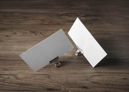 Blank business cards on wood background. For promotion of corporate identity.