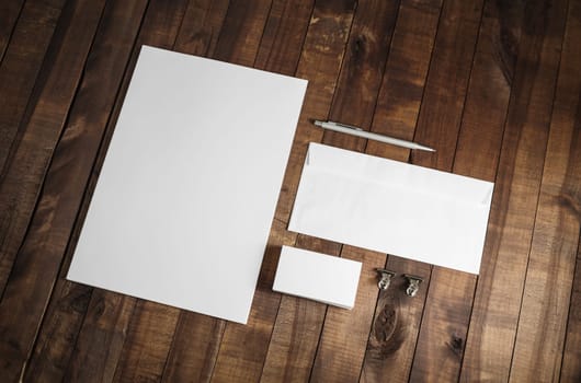Photo of blank stationery set on wood table background. Corporate identity template. Responsive design mockup.