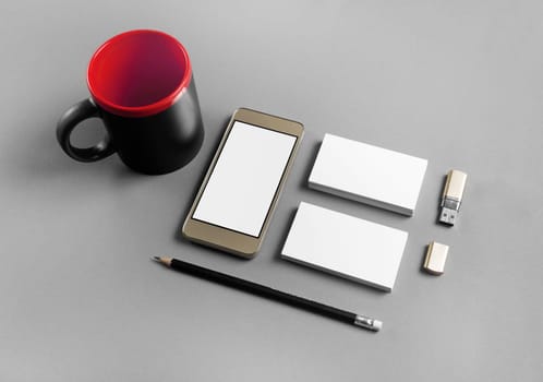 Brand ID elements for placing your design. Blank corporate stationery and gadgets on gray paper background.