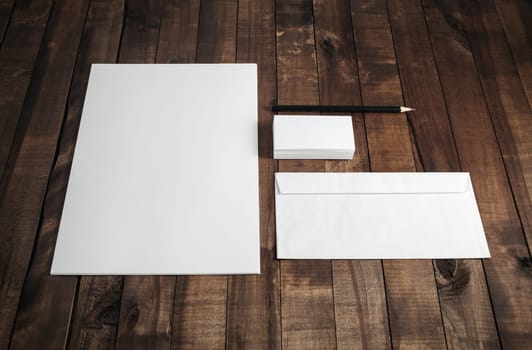 Photo of blank stationery set on wood table background. Corporate identity mock up for placing your design.