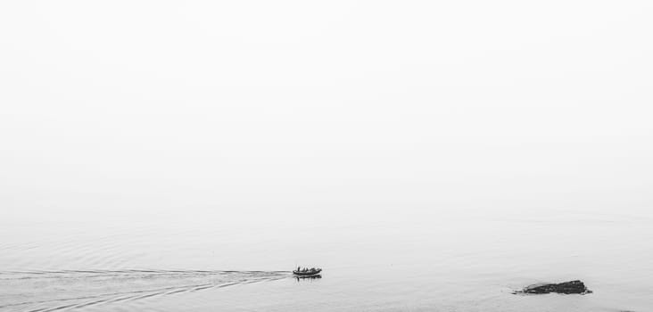Marazion, England -  May 2018 : Small motor boat with people sailing in Cornish bay, Cornwall, England, UK