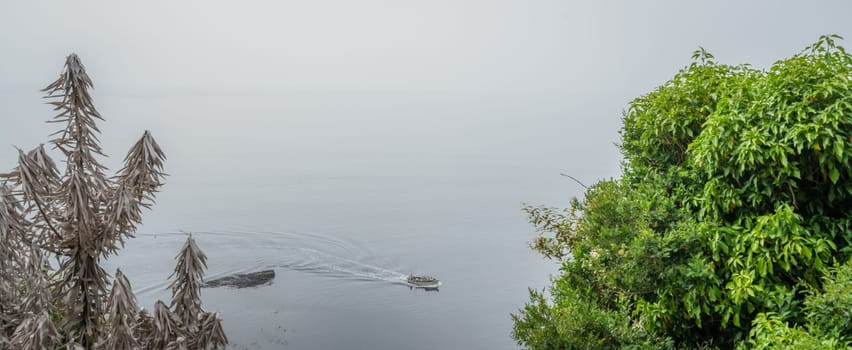 Marazion, England -  May 2018 : Small motor boat with people sailing in Cornish bay, Cornwall, UK