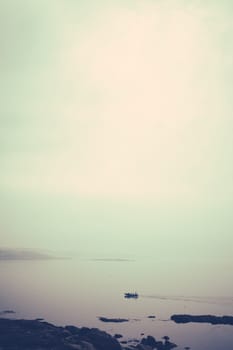 Marazion, England -  May 2018 : Small motor boat with people sailing in Cornish bay, Cornwall, England, UK