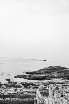 Marazion, England -  May 2018 : Small motor boat with people sailing in Cornish bay, Cornwall, England, UK