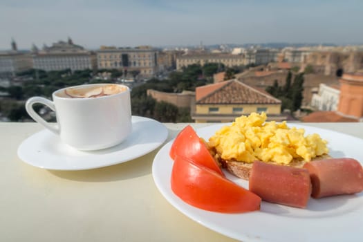 Healthy breakfast with tomato, sausage, scramble eggs and coffee