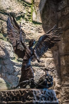 Marazion, England -  May 2018 : Sculpture depicting angel killing demon or devil in St Michael`s Mount castle chapel, Cornwall, UK