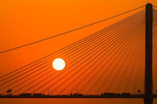 Silhouette of a bridge under setting sun