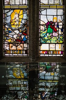 Marazion, England -  May 2018 : Victorian stained glass church window in St Michael`s Mount castle chapel, depicting saints and various religious scenes, Cornwall, UK