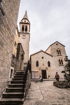 Budva, Montenegro - April 2018 : Courtyard and stairs to the bell tower of the Church of St Ivan