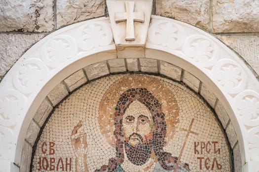 Cetinje, Montenegro - April 2018 : Religious mosaic depicting Jesus Christ above home entrance to house