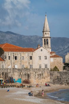 Budva, Montenegro - April 2018 : Families having fun on the beach in front of Old Town