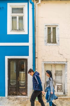 Cetinje, Montenegro - April 2018 : Couple walking in front of the colorful home facades in Cetinje, former capital town