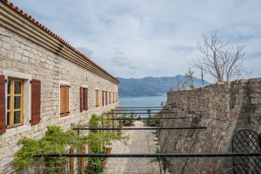 Budva, Montenegro - April 2018 : Interior of buildings and high walls of the old town fort in Budva, Montenegro