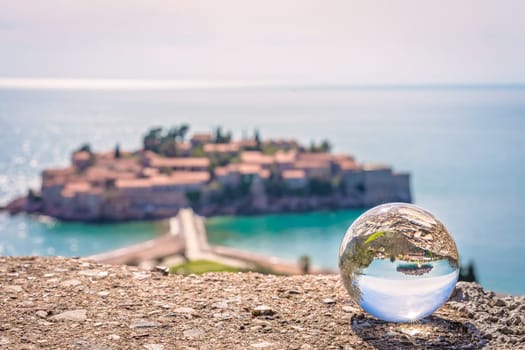 Sveti Stefan, Montenegro - April 2018 : Landmark historical old town reflected in large transparent glass ball