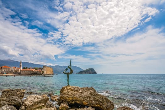 Budva, Montenegro - April 2018 :  The statue of Ballerina Dancer, standing on the rock, Budva landmark, Montenegro