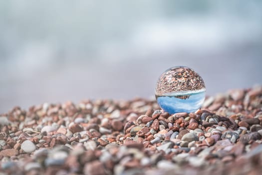Sveti Stefan, Montenegro - April 2018 : Landmark historical old town reflected in large transparent glass ball