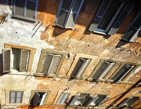 Facade of an Ancient residential building with patterned windows and shutters