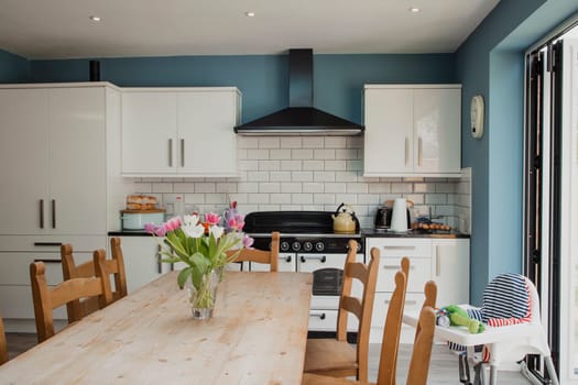 Wide angle view of a kitchen interior. There are no people within the image.