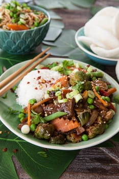 Chinese food with beef, rice and veggies