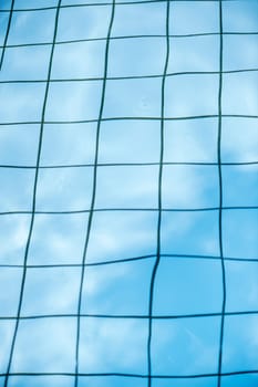 View of the bottom of a tiled swimming pool with distorted joints.