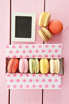 Colorful French macarons in box with dots