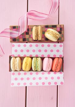 Colorful French macarons in box with dots