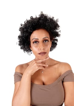 A close up portrait of a woman in a brown dress with fussy black hair.on hand under her chin, isolated for white background.