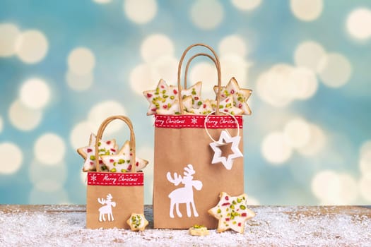 Handmade christmas gifts with paper bags on blue rustic background