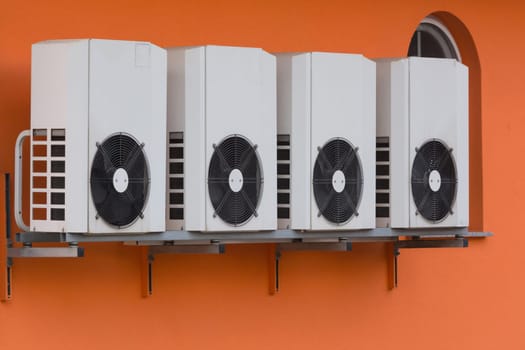 Air conditioning compressors newly installed on a house wall