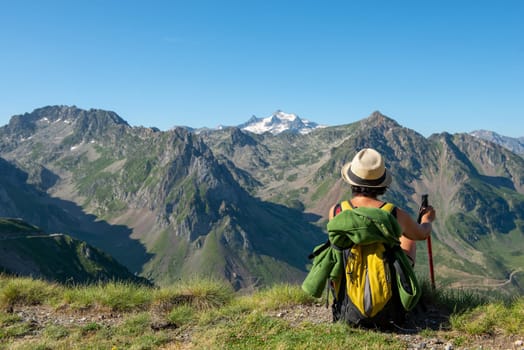 a woman hiker looking at the Pyrenees mountains
