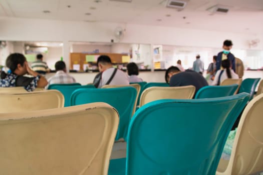 Blurred people and patient waiting for the doctor, hospital activities background