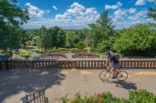 London, England -  July 2018 : Man riding on his bicycle in the Terrace Gardens near Richmond Park