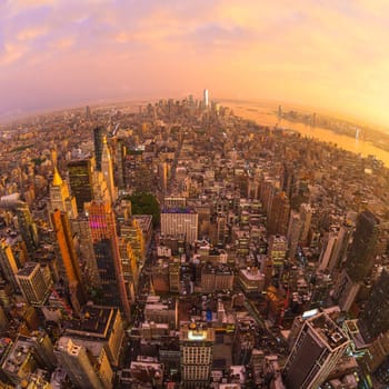 New York City skyline with Manhattan skyscrapers at dramatic vibrant after the storm sunset, USA. Rainbow and lightnings can be seen in background over Brooklyn bridge.
