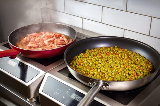 Low peas and pancetta cooked in pan on electric oven