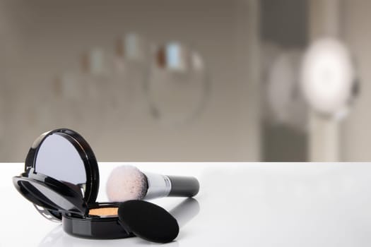 Decorative composition of cosmetics on white table with blurred bath background. Template for your display product montage. Space.
