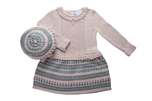 Clothes for children. A beautiful pink bright girl dress and hat with colorful pattern isolated on a white background. Children fashion.