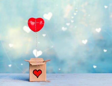lovely gift box with red heart on blue romantic background