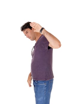 A young very handsome tall man standing in jeans and a t-shirt with.one hand up saying no, isolated for white background.