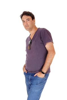 A young very handsome tall man standing in jeans and a shirt with.his hands in his pocket, isolated for white background.