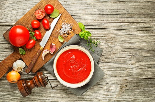 Fresh ingredients for cooking tomato sauce on wooden background place for text. Vegan food vegetarian and healthy cooking concept.